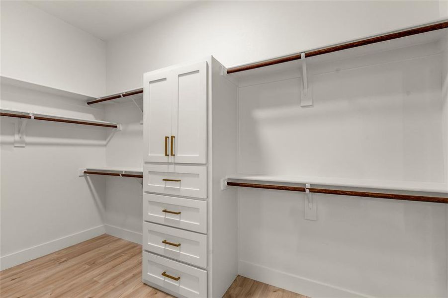 Spacious closet featuring light wood finished floors Spacious closet featuring light wood finished floors