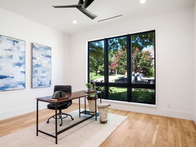 Office area featuring light wood finished floors, ceiling fan, and recessed lighting