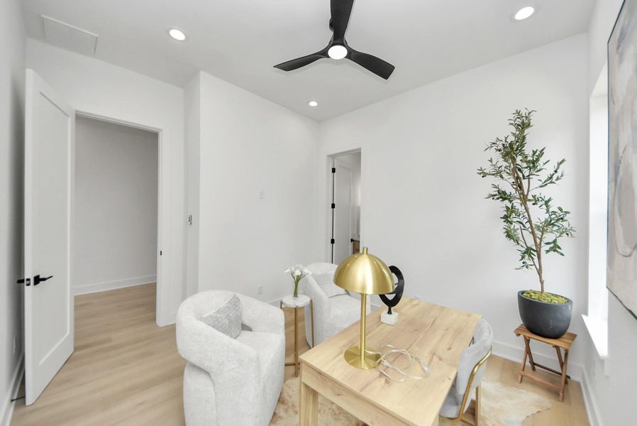 Versatile office or sitting room with modern furnishings and abundant natural light.