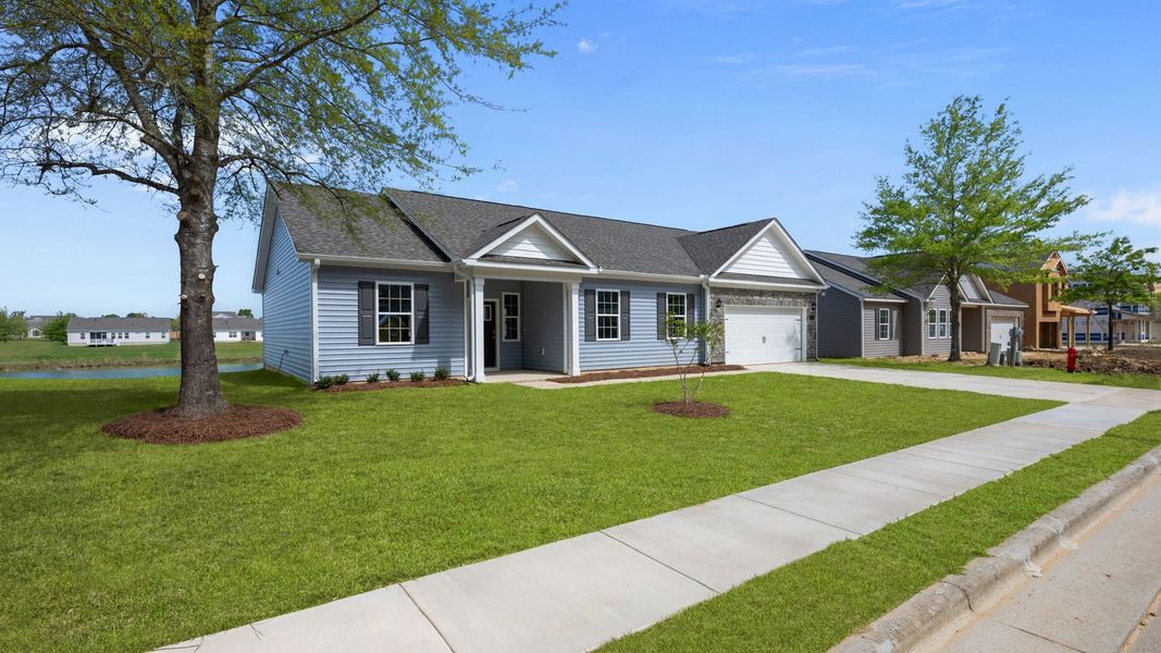 Front exterior of a new home in Tyler - Home on the Lake, New Bern, NC, highlighting curb appeal (Image 22).