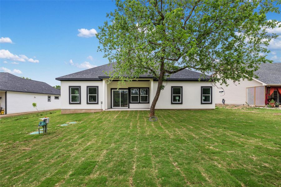 Rear exterior with white siding and black trim windows
