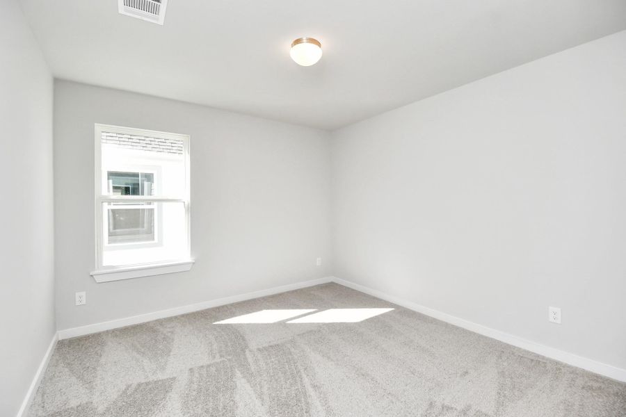 Discover another perspective of the secondary bedroom! Sample photo of completed home with similar floor plan. Actual colors and selections may vary.