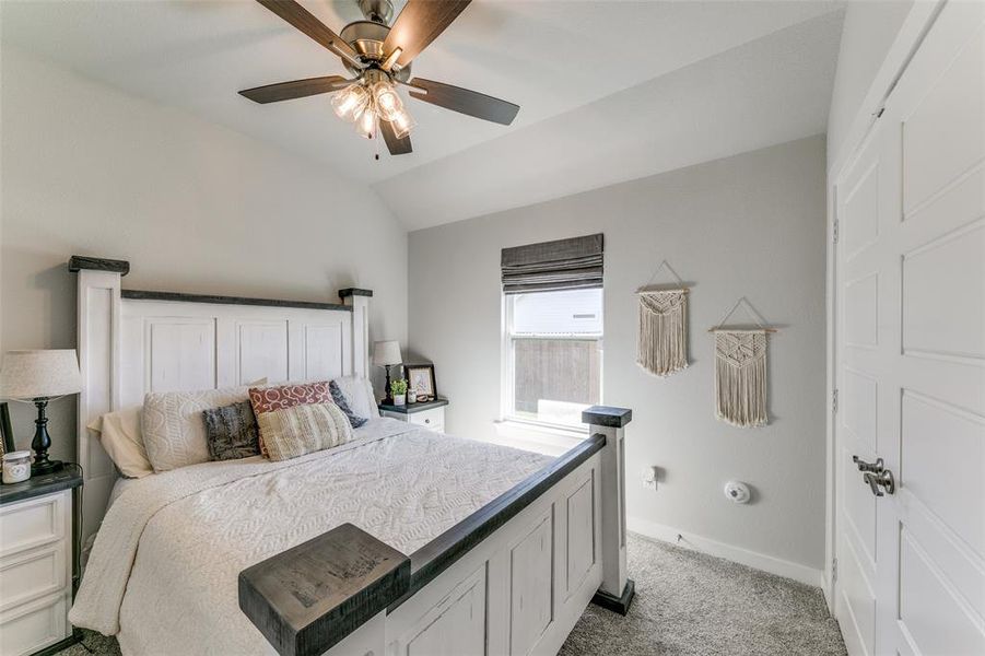 Bedroom #3 with light carpet, vaulted ceiling, and ceiling fan