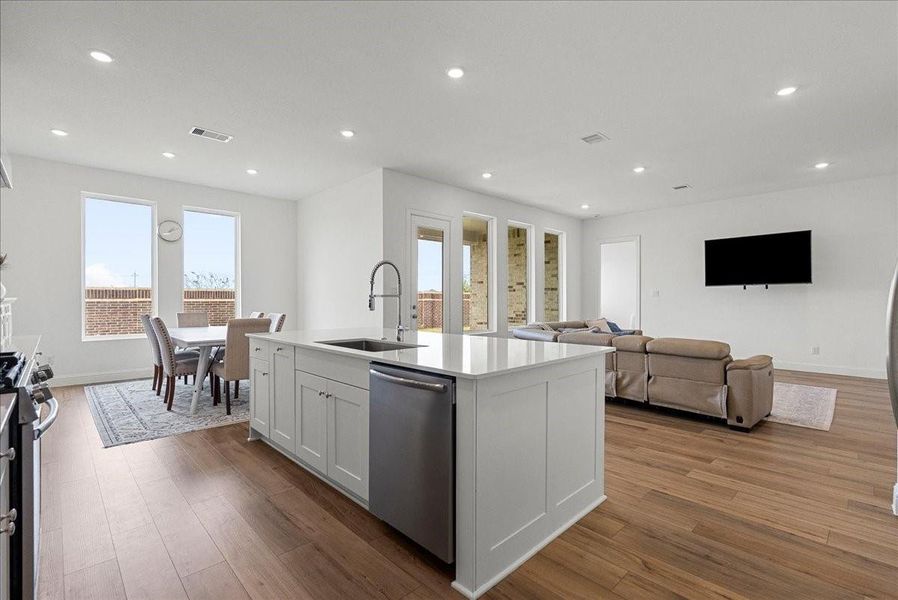 The chef’s eat-in island kitchen is the heart of the home, featuring lengthy quartz countertops, an abundance of upgraded cabinetry with crown molding, a designer backsplash, and stainless steel appliances. The chef’s eat-in island kitchen is the heart of the home, featuring lengthy quartz countertops, an abundance of upgraded cabinetry with crown molding, a designer backsplash, and stainless steel appliances.