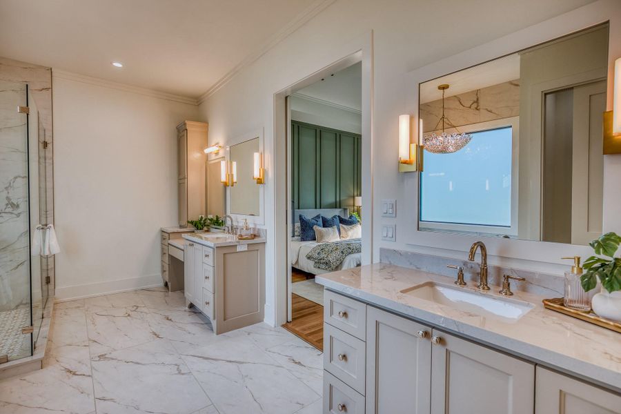 Bathroom featuring crown molding, a marble finish shower, two vanities, light marble finish floors, and ensuite bathroom Bathroom featuring crown molding, a marble finish shower, two vanities, light marble finish floors, and ensuite bathroom