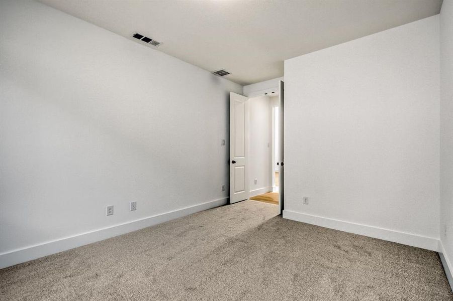Unfurnished room with carpet floors and baseboards