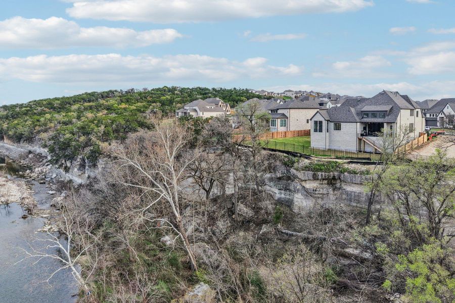 The property features a large yard with a wooden fence and a stone exterior The property features a large yard with a wooden fence and a stone exterior