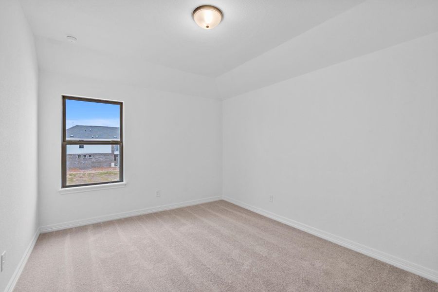 Thoughtfully designed, this secondary bedroom balances simplicity with cozy elegance.