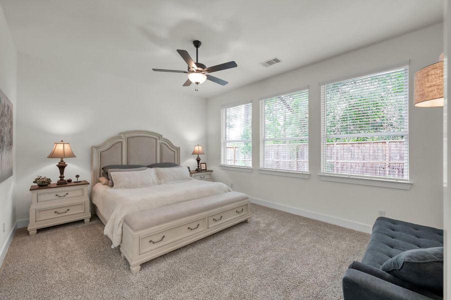 Spacious primary living area showcasing the home’s warm atmosphere, open flow, and upgraded flooring throughout, with plenty of room for additional lounge furniture or a secondary seating area.