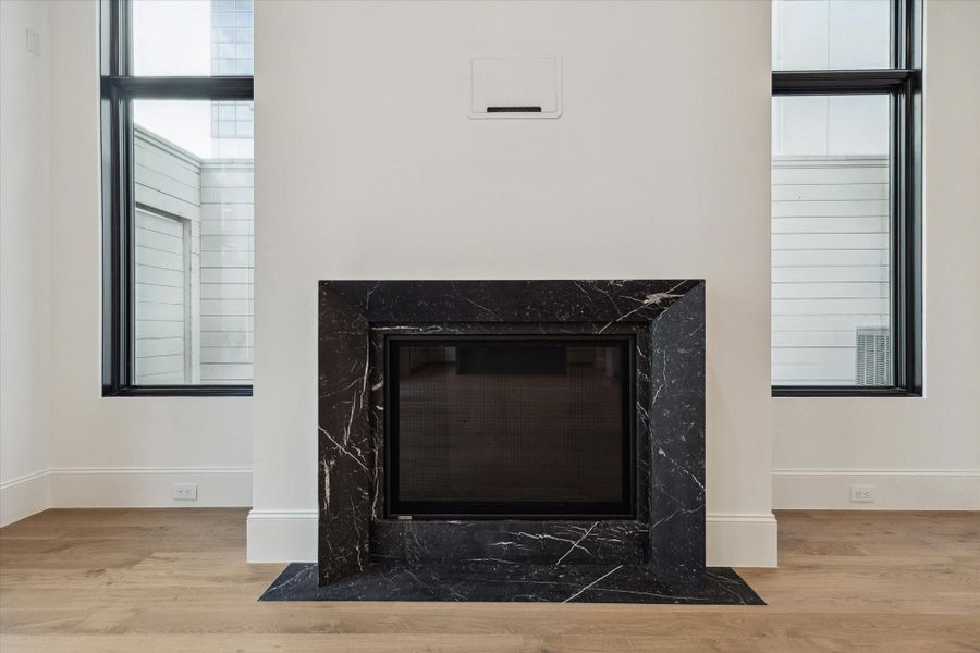 The centerpiece of the living room is this elegant 42” direct vent fireplace with Nero Marquina marble facade.