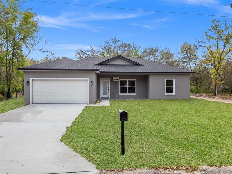 Front exterior of a new home in , Ocklawaha, FL, highlighting curb appeal (Image 20).
