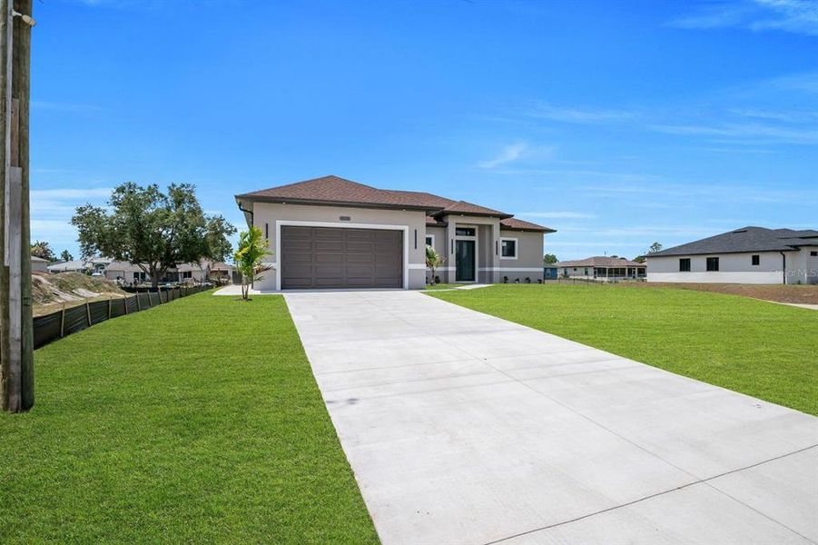 Front exterior of a new home in , Lehigh Acres, FL, highlighting curb appeal (Image 20).