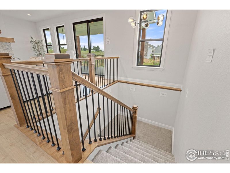 Stylish wrought-iron balusters and stained alder bannisters leading to the basement