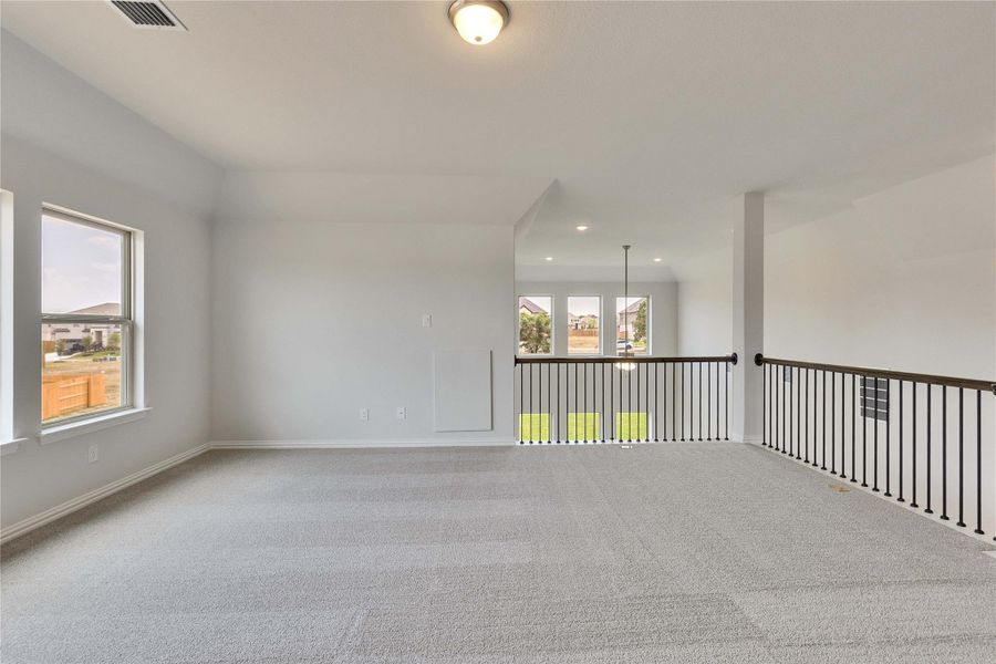 Empty room with carpet flooring and recessed lighting Empty room with carpet flooring and recessed lighting