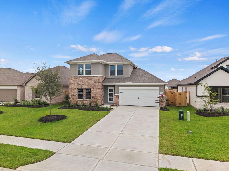 Front exterior of a new home in Windrose Green, Angleton, TX, highlighting curb appeal (Image 2). Front exterior of a new home in Windrose Green, Angleton, TX, highlighting curb appeal (Image 2).