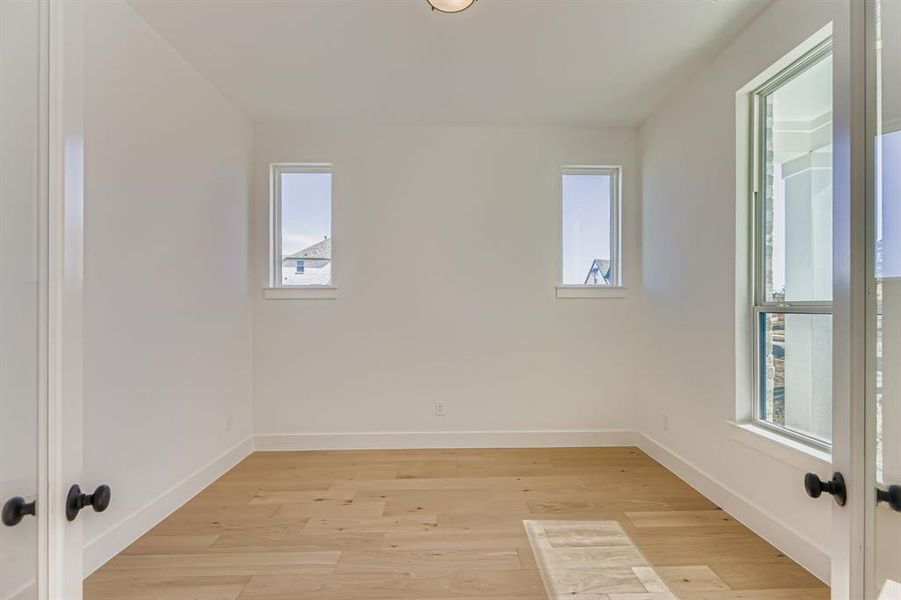 Spare room with light wood finished floors and baseboards