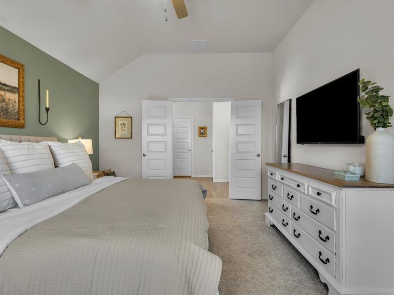 Double doors lead into the luxurious primary ensuite.