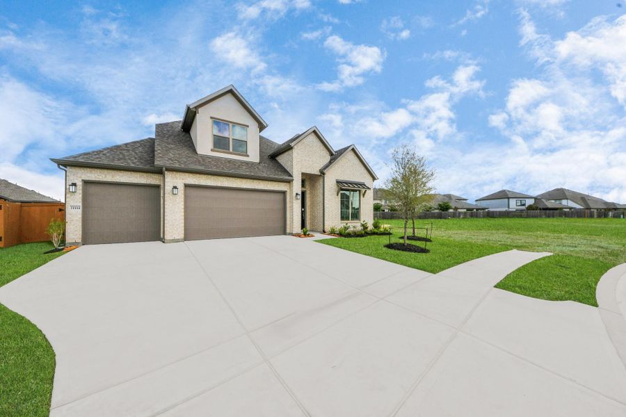 Front exterior of a new home in Marvida, Cypress, TX, highlighting curb appeal (Image 8).