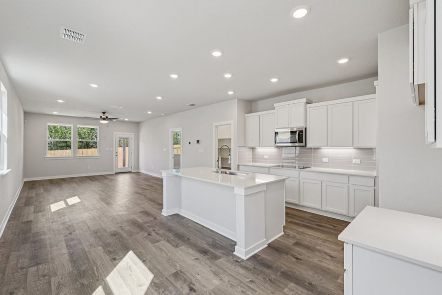 A kitchen with white cabinets.