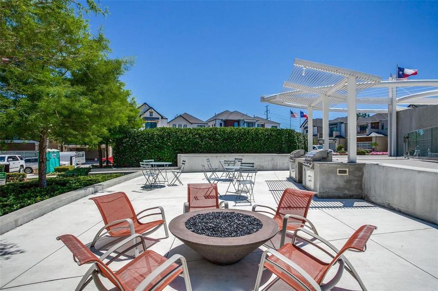 View of patio with a fire pit, exterior kitchen, area for grilling, and a pergola