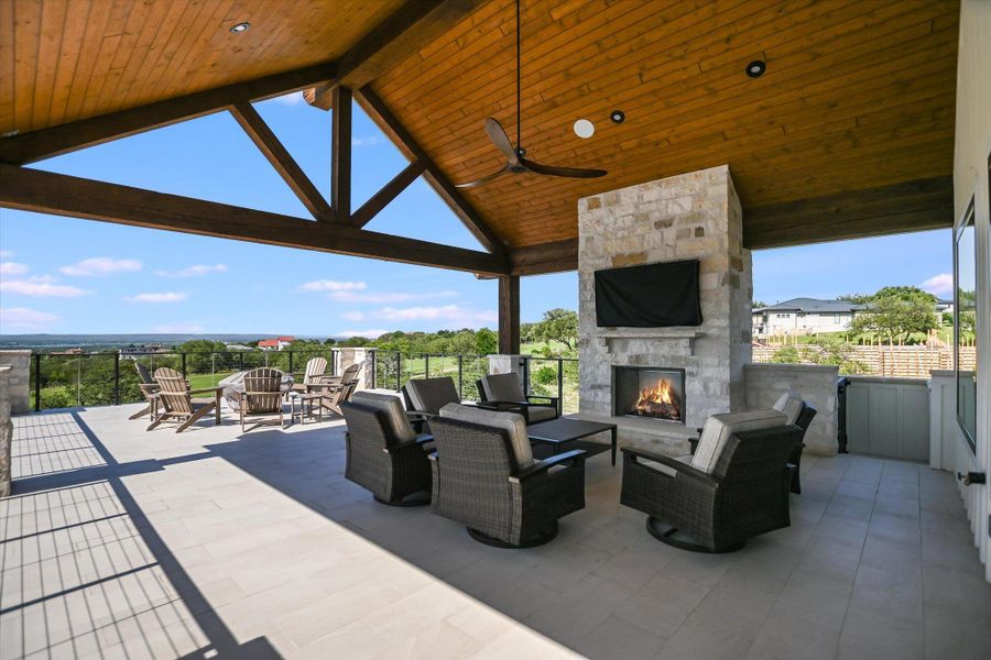 View of patio featuring an outdoor living space with a fireplace and ceiling fan View of patio featuring an outdoor living space with a fireplace and ceiling fan