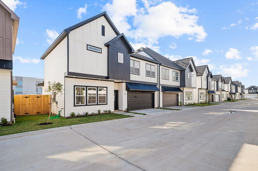 Front exterior of a new home in Metro Village, Houston, TX, highlighting curb appeal (Image 1).