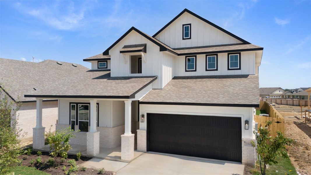View of front facade with roof with shingles, covered porch, brick siding, and concrete driveway View of front facade with roof with shingles, covered porch, brick siding, and concrete driveway