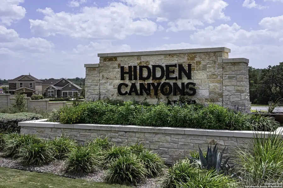 Front exterior of a new home in Hidden Bluffs at TRP, San Antonio, TX, highlighting curb appeal (Image 2). Front exterior of a new home in Hidden Bluffs at TRP, San Antonio, TX, highlighting curb appeal (Image 2).