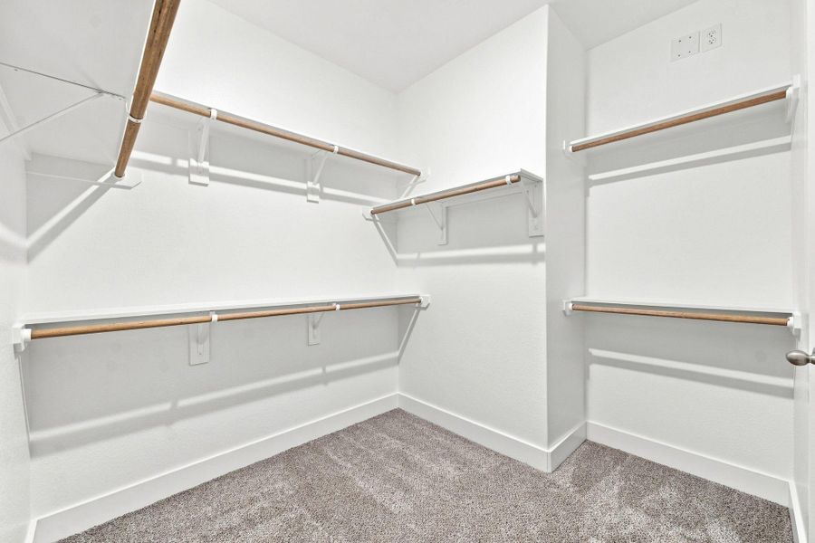 Another view of the spacious primary walk-in closet highlighting the generous built-in storage and hanging space. Another view of the spacious primary walk-in closet highlighting the generous built-in storage and hanging space.