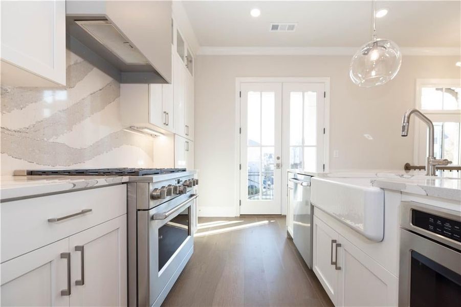 Upgraded designer finishes:  GE Profile appliances, farm sinks and vent hood options.  Image is of previously built Chamberlain.