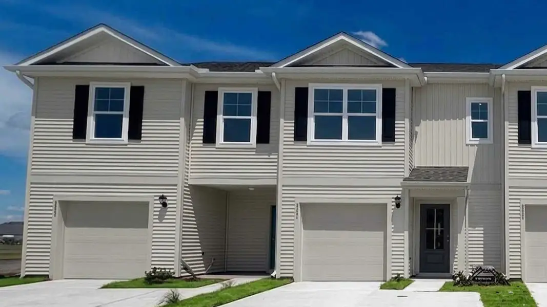 Front exterior of a new home in The Landing at Sidbury Station, Castle Hayne, NC, highlighting curb appeal (Image 1). Front exterior of a new home in The Landing at Sidbury Station, Castle Hayne, NC, highlighting curb appeal (Image 1).