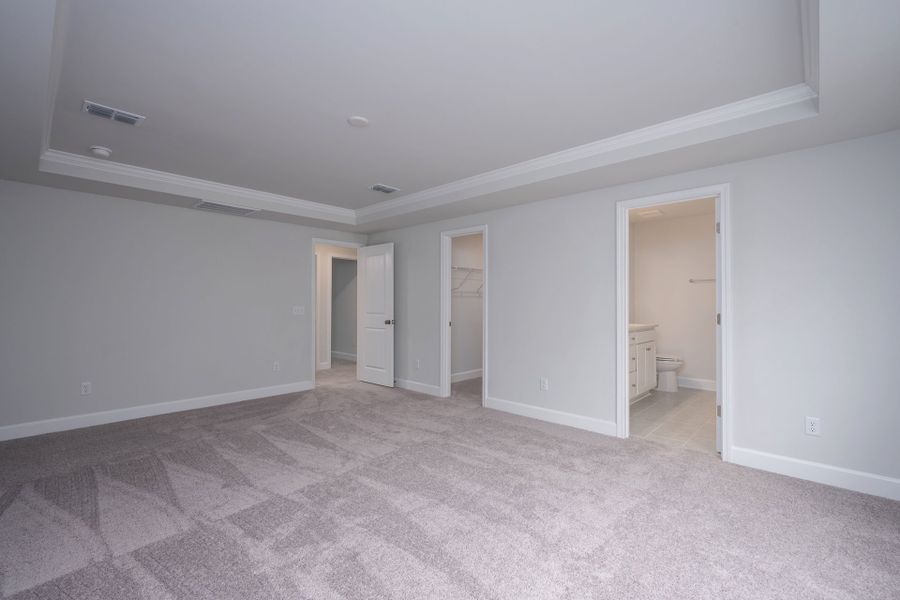 An elegant Owner's Suite with space to relax and tray ceiling details. An elegant Owner's Suite with space to relax and tray ceiling details.