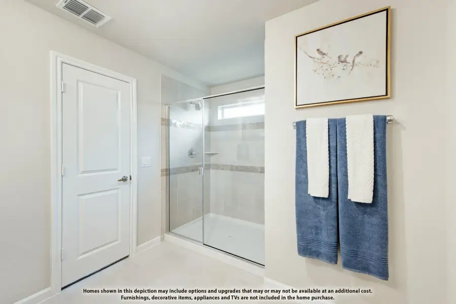 Bathroom with glass-enclosed walk-in shower, tile walls, and light tile floors