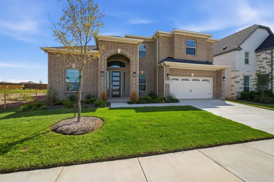 Front exterior of a new home in Green Meadows, Celina, TX, highlighting curb appeal (Image 2).