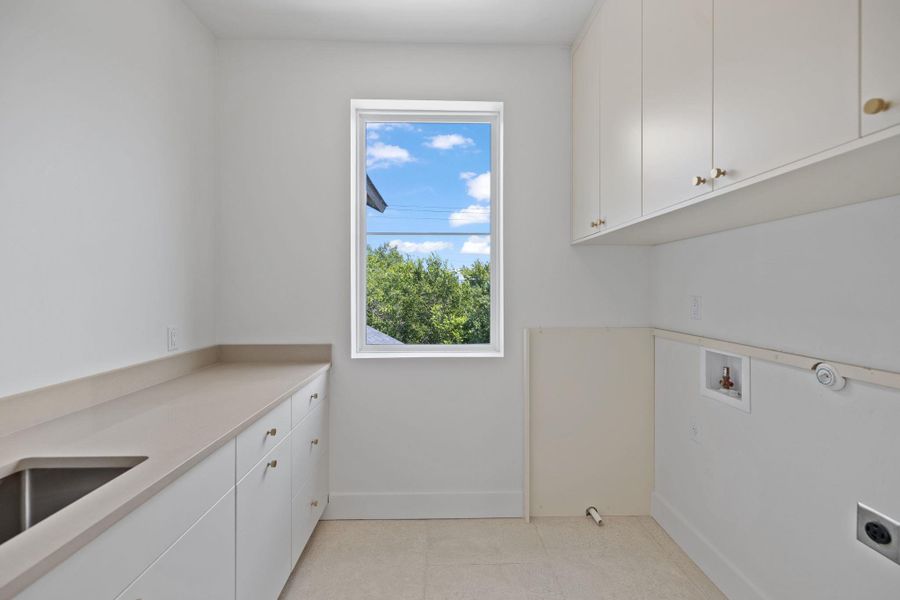 Laundry area with cabinet space, hookup for a washing machine, gas dryer hookup, and electric dryer hookup Laundry area with cabinet space, hookup for a washing machine, gas dryer hookup, and electric dryer hookup