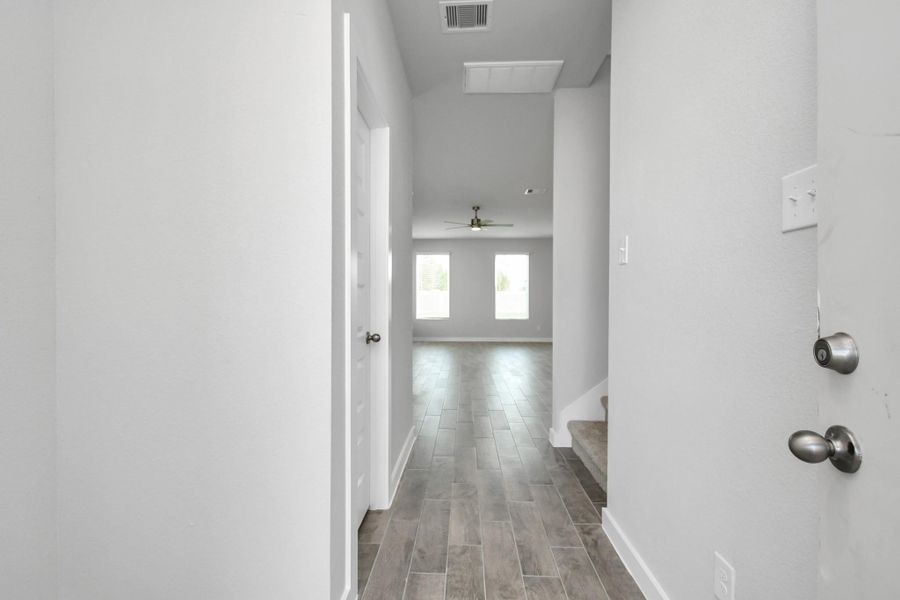 As you step into the threshold of this luxurious home, you'll soon be welcomed by an elegant glass door (to be installed). Inside, soaring ceilings amplify the spaciousness, while the refined wood-look tile flooring and oversized baseboards exude sophistication and charm. Sample photo of completed home with similar floor plan. Actual colors and selections may vary.