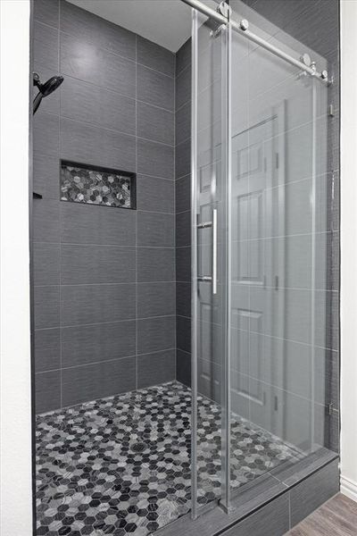 Bathroom with hardwood / wood-style flooring and walk in shower