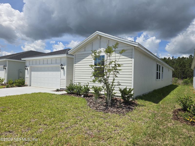 Front exterior of a new home in Lakes at Bella Lago - Signature Series, Green Cove Springs, FL, highlighting curb appeal (Image 2). Front exterior of a new home in Lakes at Bella Lago - Signature Series, Green Cove Springs, FL, highlighting curb appeal (Image 2).