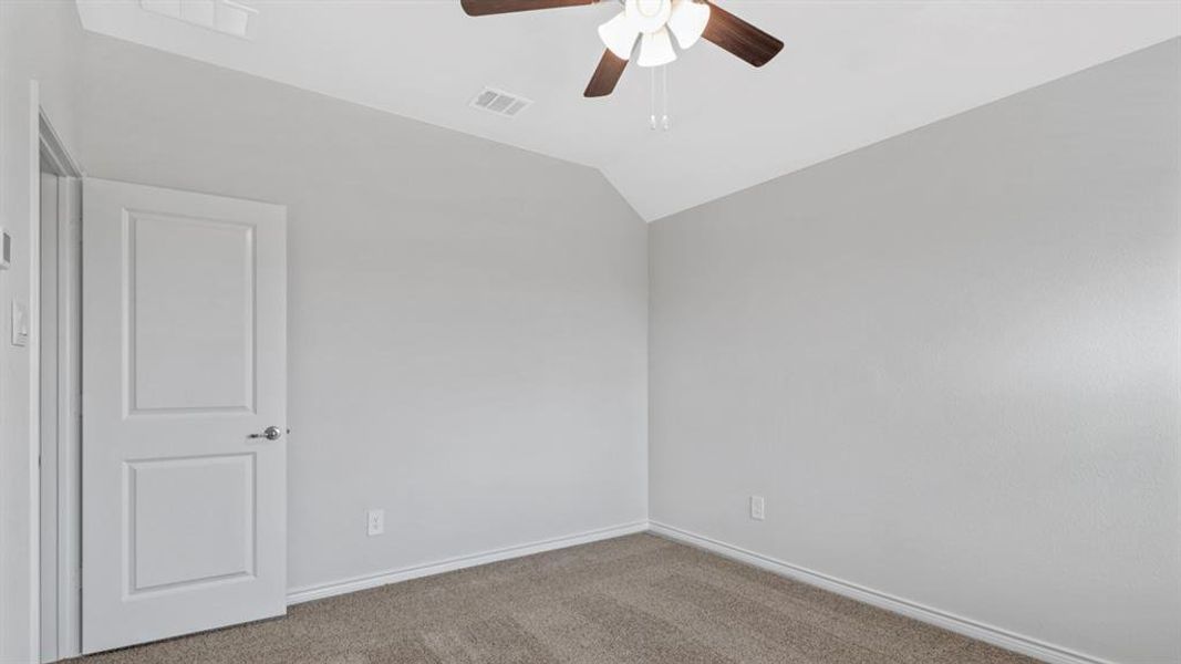 Neutral-toned carpeting and light gray walls create a versatile backdrop