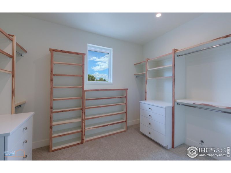 Primary Closet With Built-In Dresser Drawers And Cedar Trim.