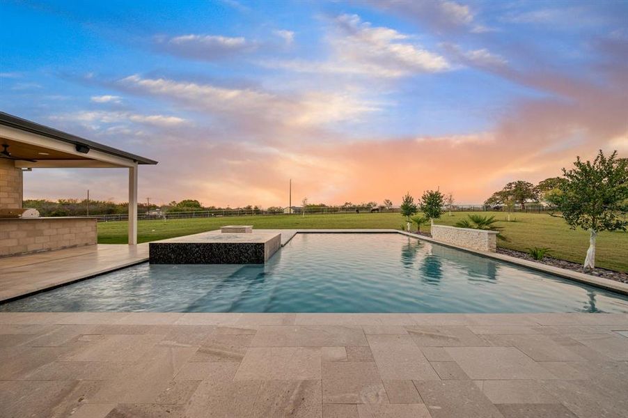 Expansive pool and open sunset backdrop. Expansive pool and open sunset backdrop.