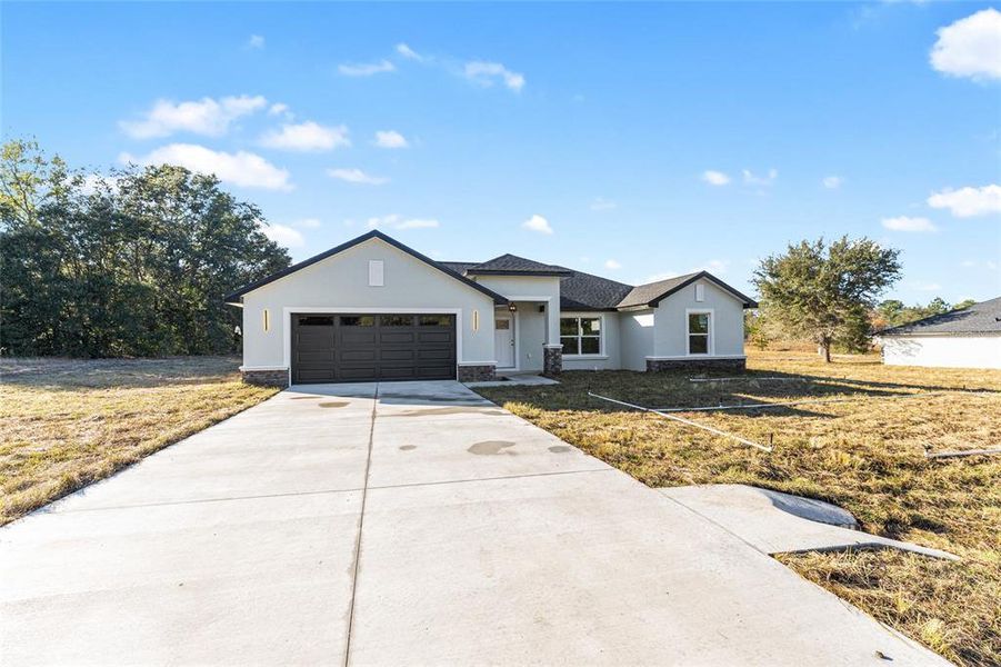 Front exterior of a new home in , Dunnellon, FL, highlighting curb appeal (Image 24).