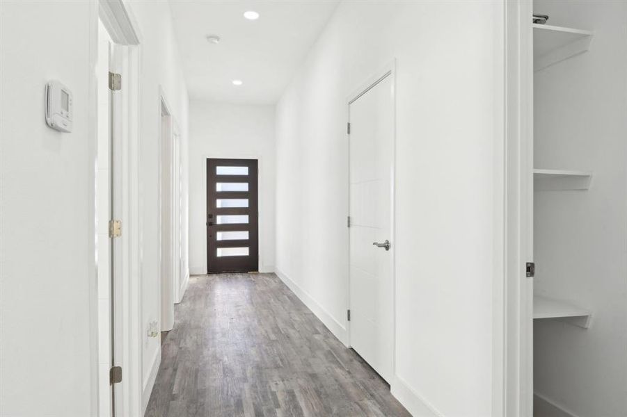 Entryway featuring baseboards, wood finished floors, and recessed lighting