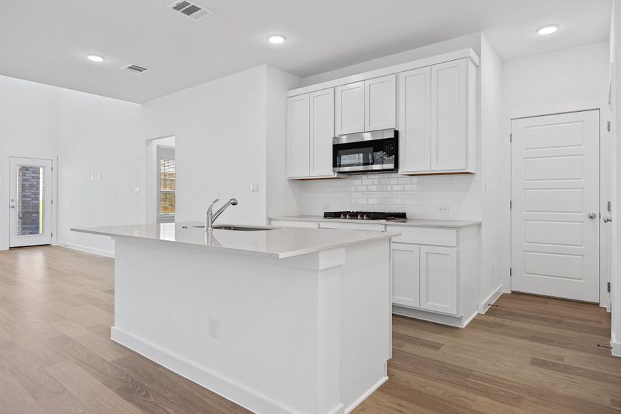 Kitchen in the Mesquite home plan by Trophy Signature Homes – REPRESENTATIVE PHOTO Kitchen in the Mesquite home plan by Trophy Signature Homes – REPRESENTATIVE PHOTO