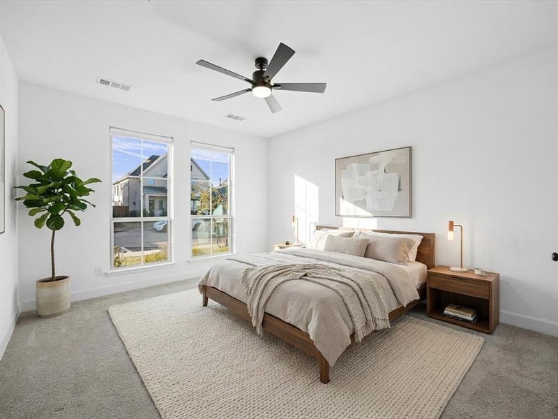 Primary Bedroom featuring a ceiling fan and light carpet Primary Bedroom featuring a ceiling fan and light carpet