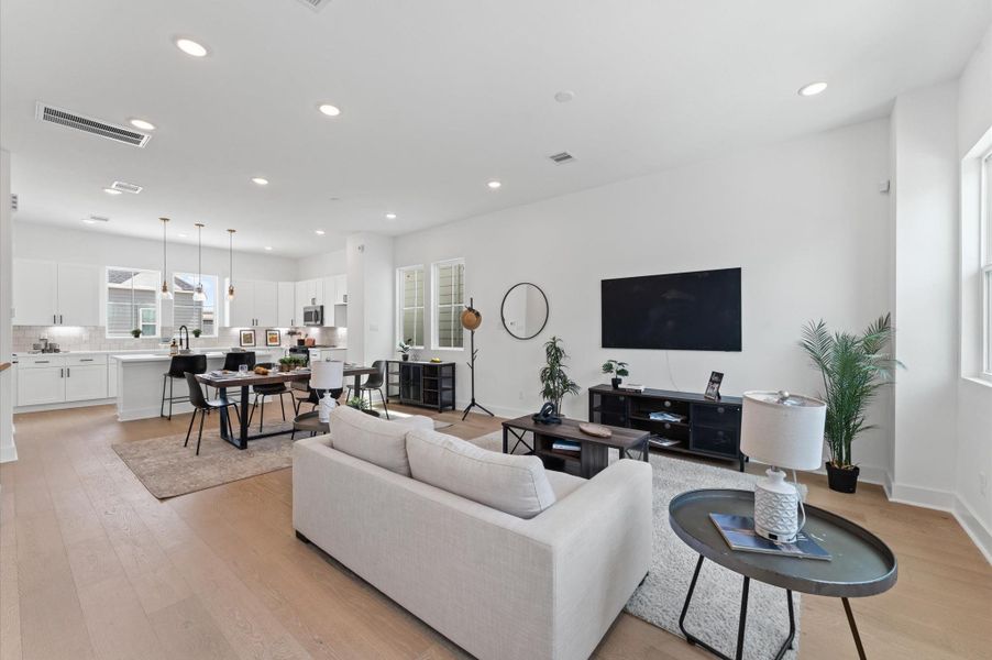 Designed for modern living, this open-concept space seamlessly unites the kitchen, dining, and living areas into one harmonious hub.