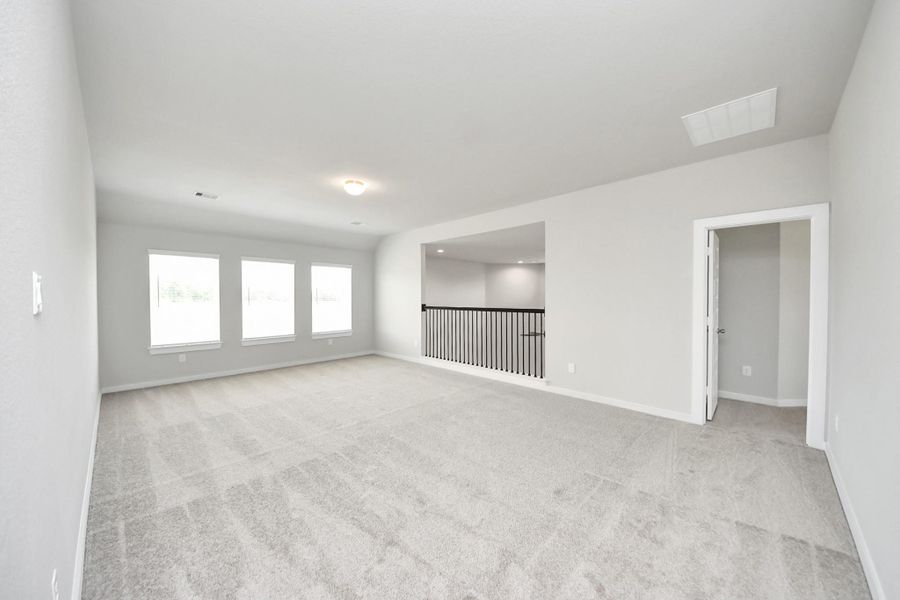 Come upstairs and enjoy a day of leisure in this fabulous game room! This is the perfect hangout spot or adult game room! Features plush carpet, high ceilings, custom paint and windows for plenty of natural light. Sample photo of completed home with similar floor plan. Actual colors and selections may vary. Come upstairs and enjoy a day of leisure in this fabulous game room! This is the perfect hangout spot or adult game room! Features plush carpet, high ceilings, custom paint and windows for plenty of natural light. Sample photo of completed home with similar floor plan. Actual colors and selections may vary.