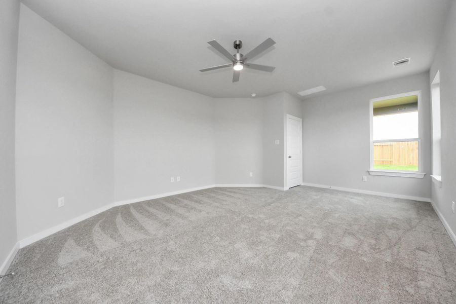 Discover another perspective of this spacious primary bedroom. Sample photo of completed home with similar floor plan. Actual colors and selections may vary.