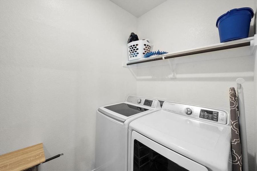 Lower level Laundry area featuring independent washer and dryer