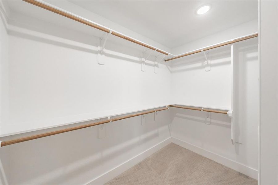 Walk in closet with light colored carpet Walk in closet with light colored carpet